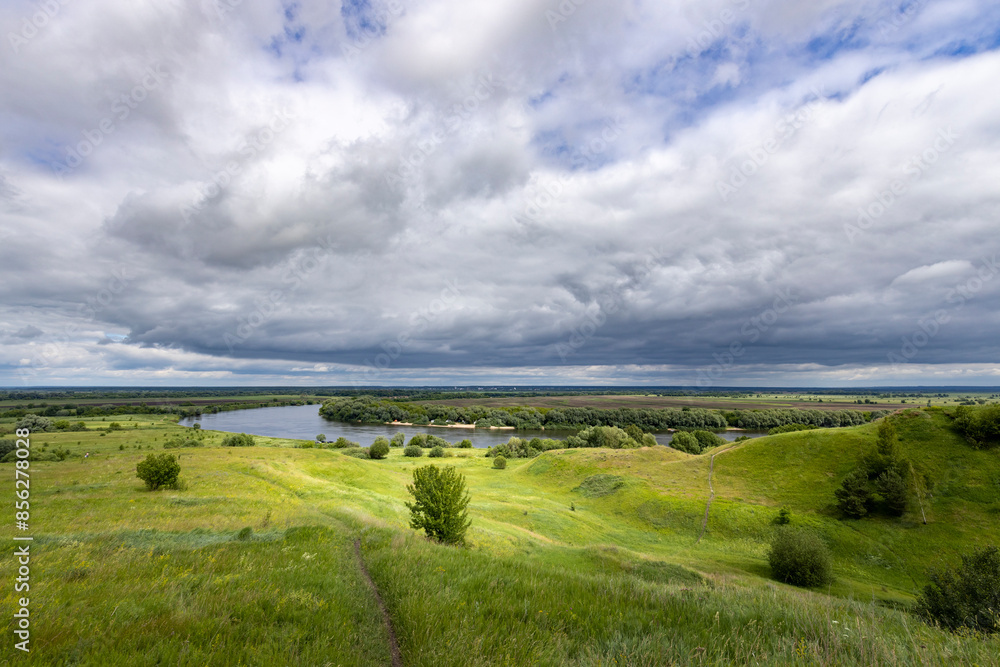 A cloudy sky with a river in the background A cloudy sky with a river in the background