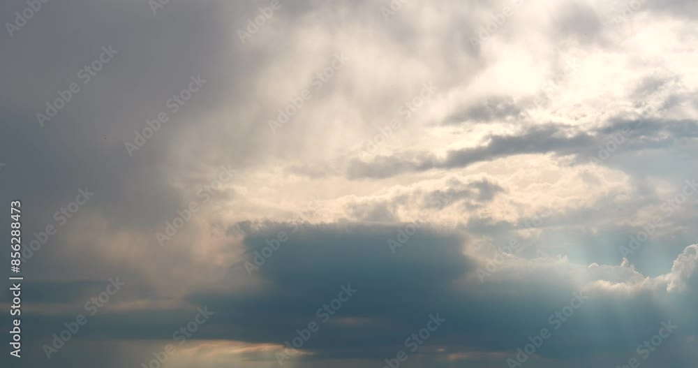 Dramatic clouds during a storm with sunshine lighting through the clouds