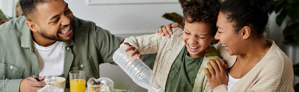 An African American family happily eating together around a table.