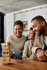 Happy African American family enjoying a game together on the couch.