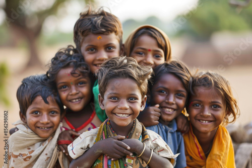 Group of diverse, cheerful multi-ethnic children from India smiling and looking at the camera outdoors