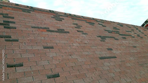 Roof in need of repair, missing shingles from storm damage