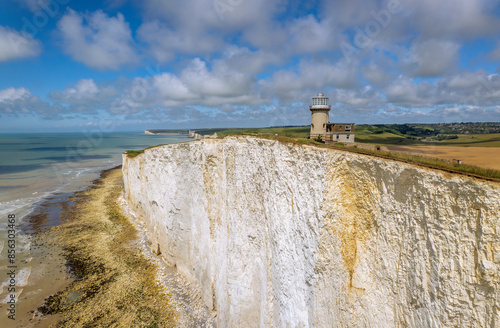 The drone aerial view of Belle Tout Lighthouse at Beachy Head, East Sussex, UK. The Belle Tout Lighthouse is a decommissioned lighthouse and British landmark located at Beachy Head, East Sussex. photo