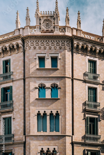 Ornate Gothic Facade of a Historical Building Under Blue Sky in Barcelona, Spain photo