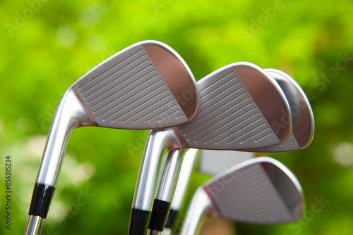 Close up view of golf clubs in a golf bag with selective focus.