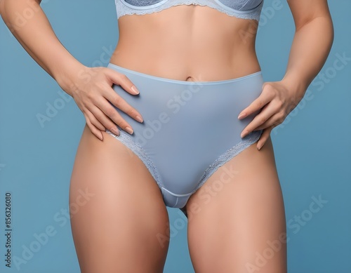 female belly . Woman Wearing Light Blue Lace Underwear Against Blue Background