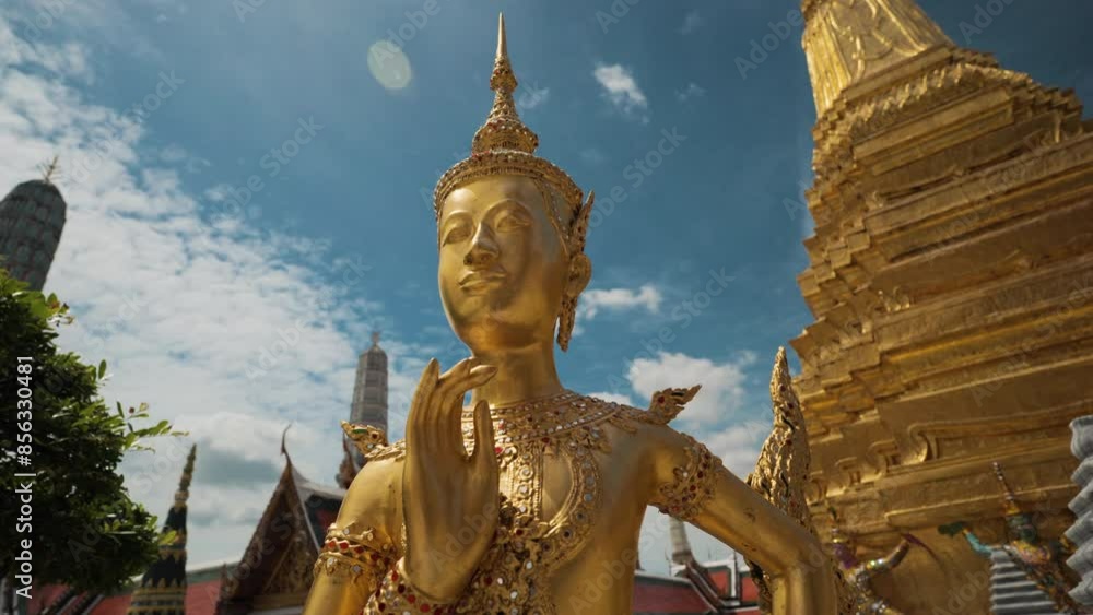 Golden angel statue at the Buddhist Temple Wat Phra Kaew grand Palace emerald buddhist temple at Bangkok, Thailand