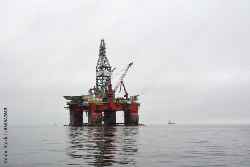 Oil drilling platform in a calm sea. Environmental pollution and industry Oil drilling platform in a calm sea. Environmental pollution and industry