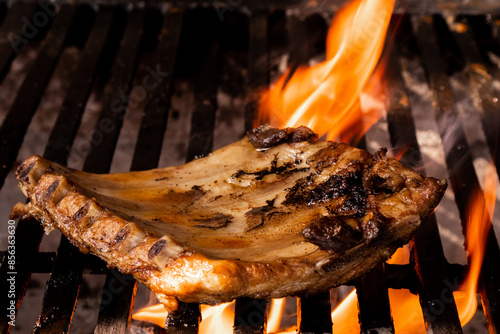Juicy grilled pork chop over open flame photo