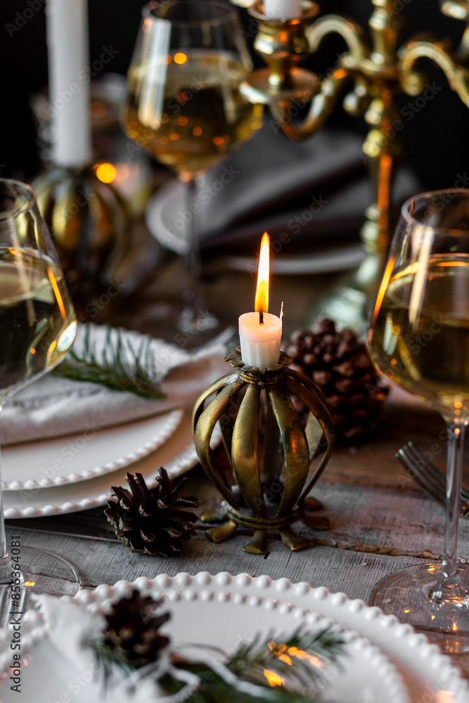 Elegant decor for Christmas family dinner. Center piece with burning candles, vintage chandelier. Zero waste eco-friendly reusable home decoration, fir tree branches. Cozy atmosphere, wooden furniture Elegant decor for Christmas family dinner. Center piece with burning candles, vintage chandelier. Zero waste eco-friendly reusable home decoration, fir tree branches. Cozy atmosphere, wooden furniture