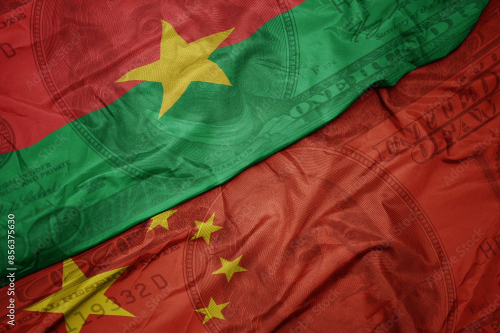 Φωτογραφία waving colorful flag of burkina faso and national flag of china on the dollar money background