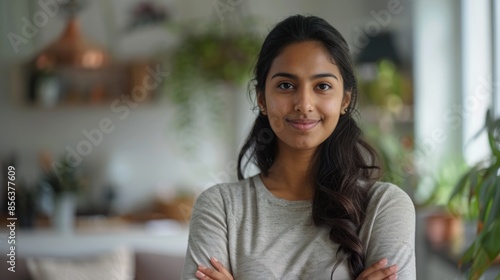 Confident Indian woman posing for head shot portrait at home.