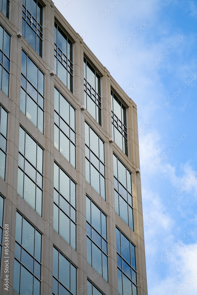 blue sky in background with building filled with windows in foreground blue sky in background with building filled with windows in foreground