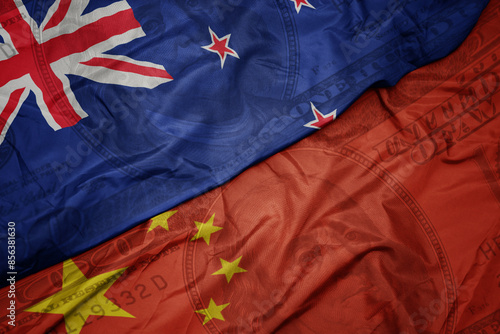 Sticker waving colorful flag of new zealand and national flag of china on the dollar money background