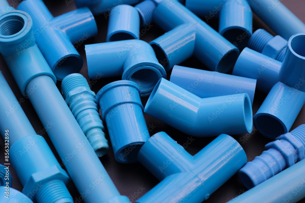 Obraz premium Plumber equipment with blue pvc pipe connections for plumbing work.