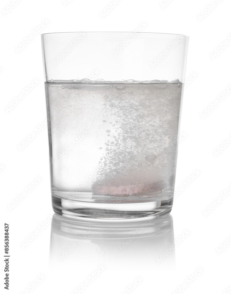 Effervescent pill dissolving in glass of water isolated on white Effervescent pill dissolving in glass of water isolated on white