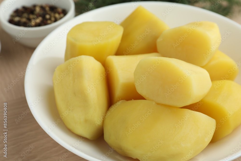 Boiled potatoes in bowl on wooden table, closeup Boiled potatoes in bowl on wooden table, closeup