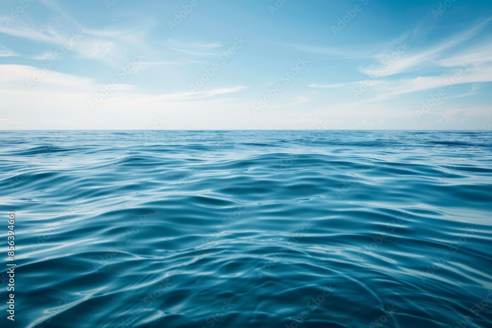 Obraz premium A serene view of a calm ocean under a clear blue sky