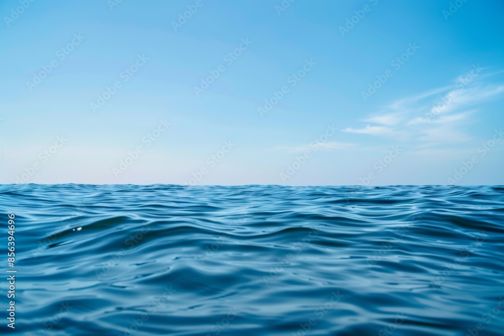 A serene view of a calm ocean under a clear blue sky A serene view of a calm ocean under a clear blue sky