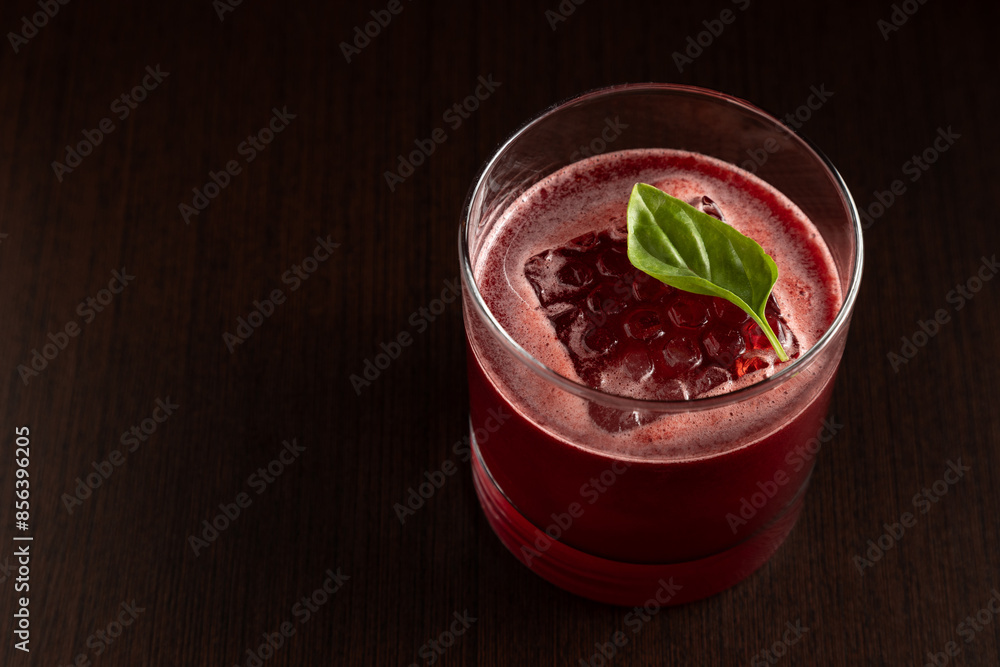 elegant cocktail in short glass decorated with basil with dark background seen from above elegant cocktail in short glass decorated with basil with dark background seen from above