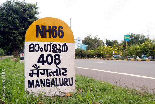 mile stone sign board (travel guide) located beside of national highway in kerala india