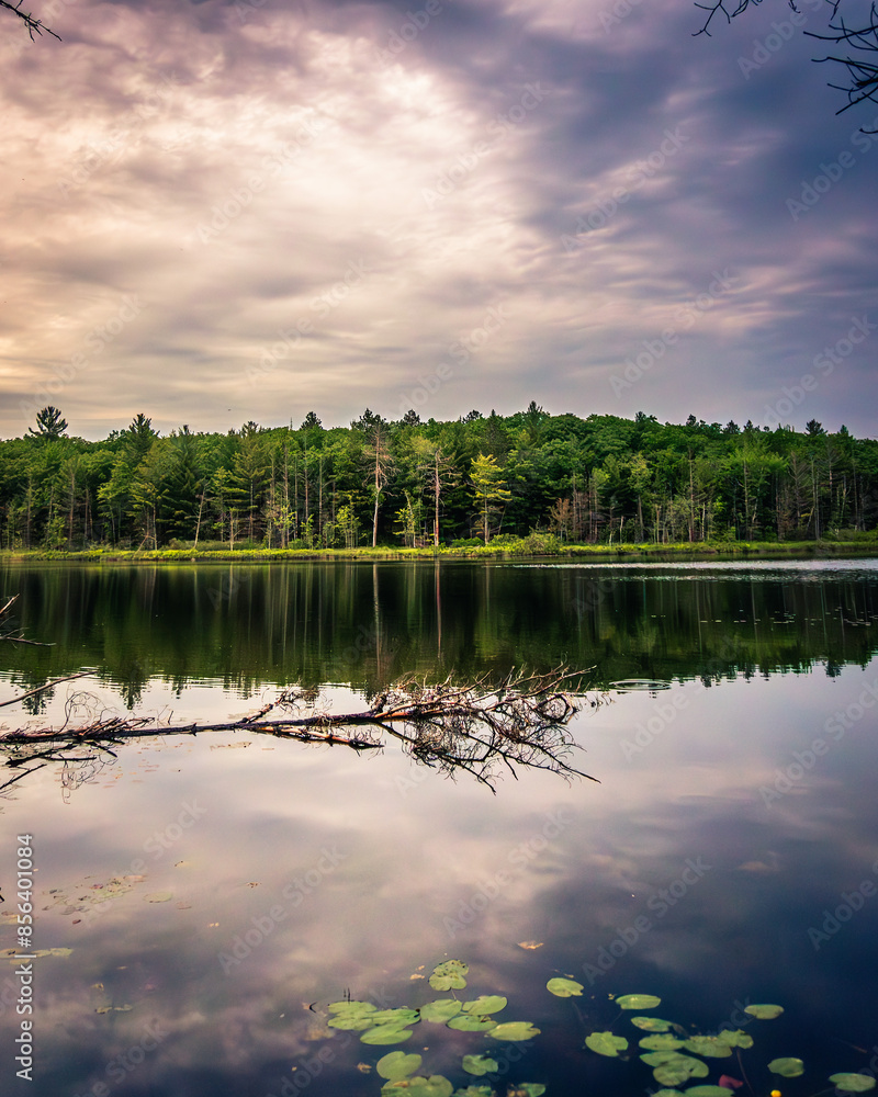 Fototapeta premium Sunset reflected on calm water