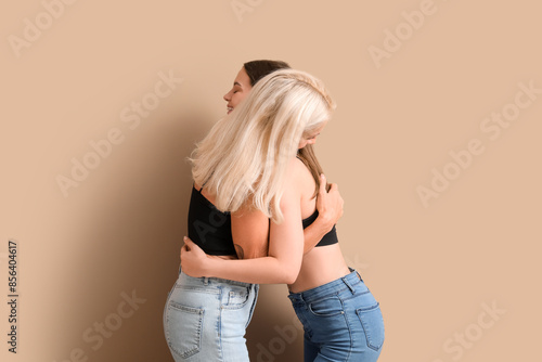 Body positive women hugging...