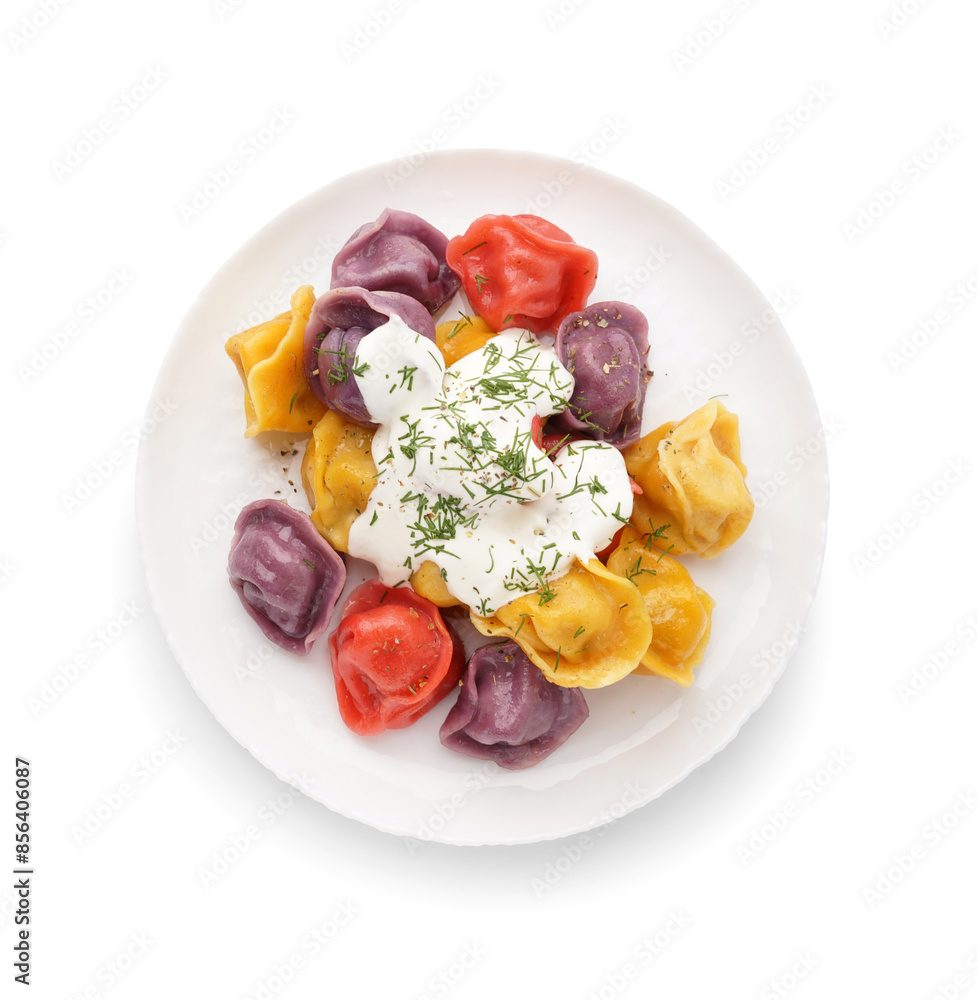 Plate of boiled colorful dumplings with sour cream and dill on white background Plate of boiled colorful dumplings with sour cream and dill on white background