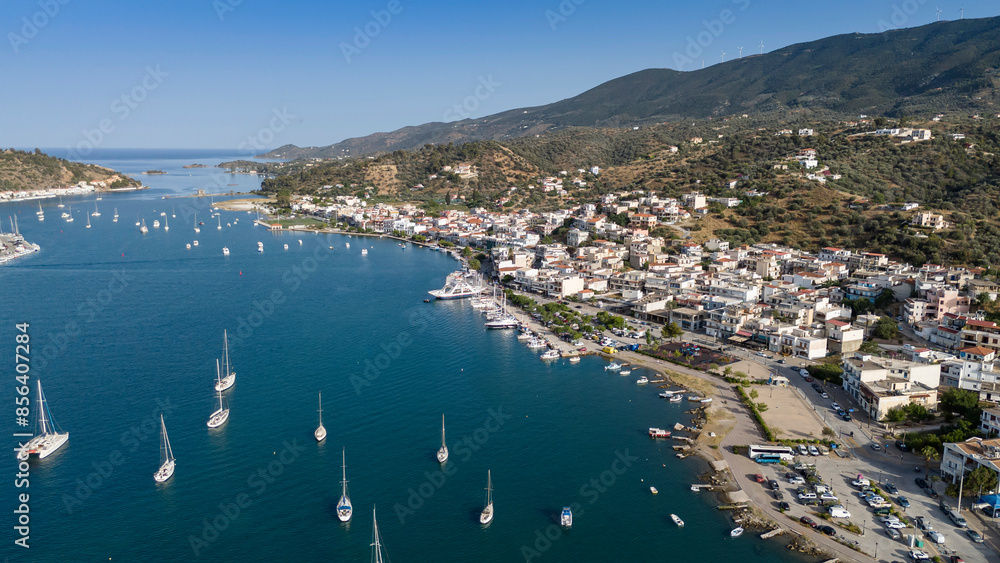 Fototapeta premium Aerial panorama of the city and harbor of Poros island in the Saronic Gulf, Greece, during a colorful summer sunset