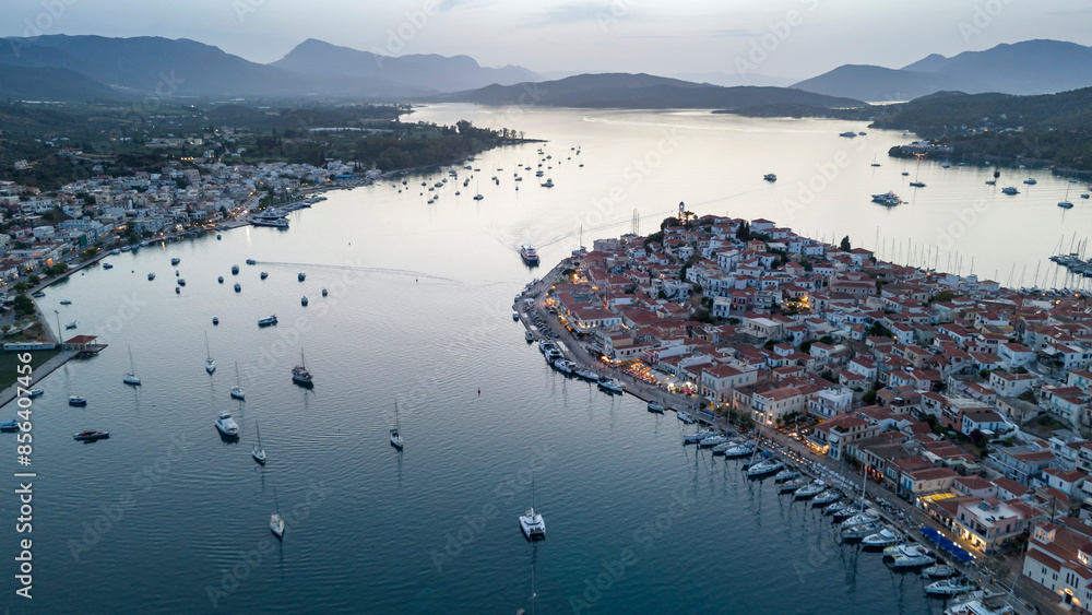 Fototapeta premium Aerial panorama of the city and harbor of Poros island in the Saronic Gulf, Greece, during a colorful summer sunset