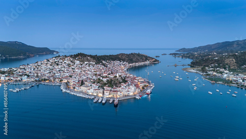 Aerial panorama of the city and harbor of Poros island in the Saronic Gulf, Greece, during a colorful summer sunset