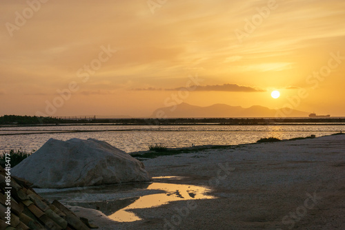 Golden hour during sunset in nature reserve of Saline di Trapani with salt fields, Contrada Nubia, Sicily, Italy photo