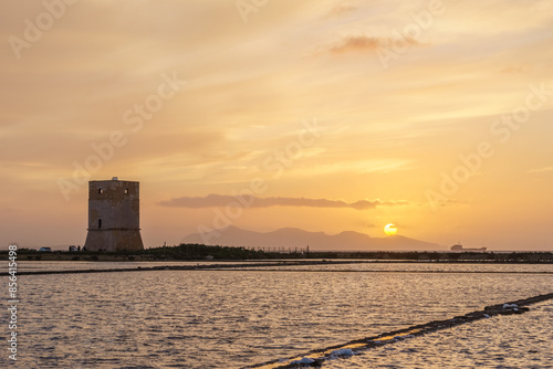 Golden hour during sunset at tower of Nubia in nature reserve of Saline di Trapani with salt fields, Contrada Nubia, Sicily, Italy photo