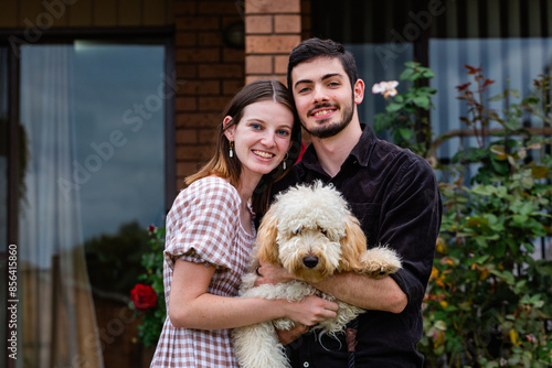 Aussie homeowner couple in their twenties with pet tamaruke dog photo