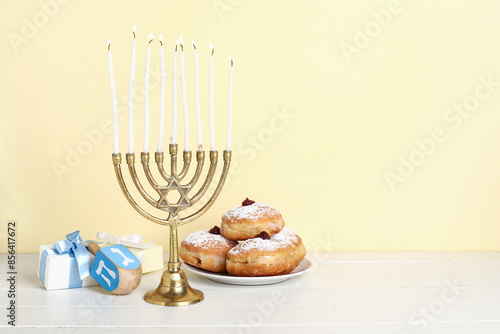 Menorah with burning candle...