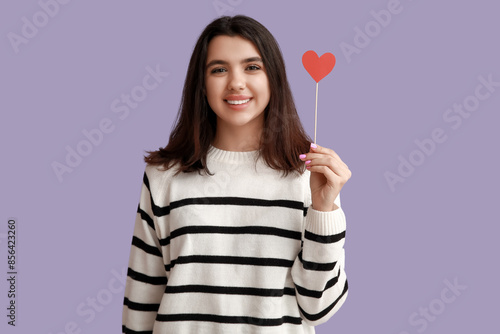Smiling young woman holding...