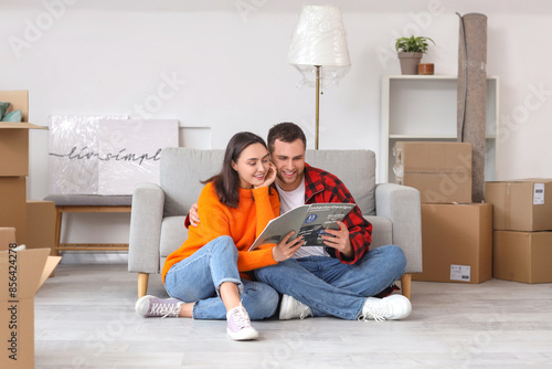 Happy young couple reading ...