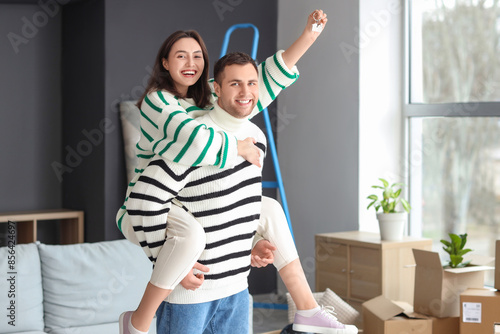Happy young couple in room ...