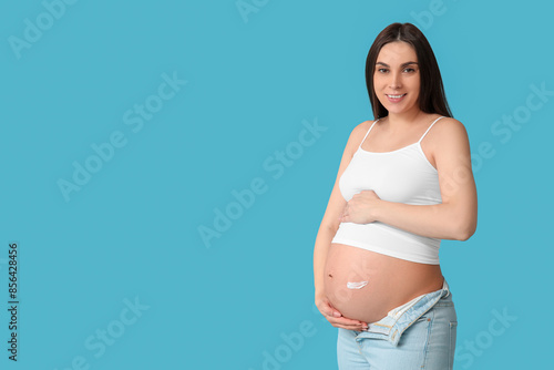 Pregnant woman applying str...
