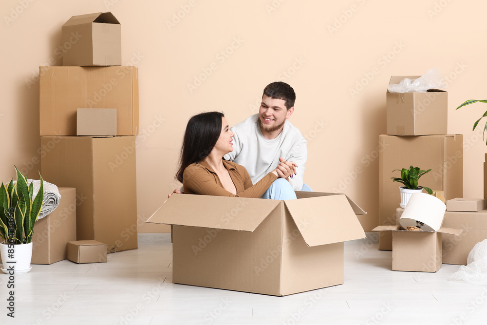Young happy couple with belongings in their new house Young happy couple with belongings in their new house