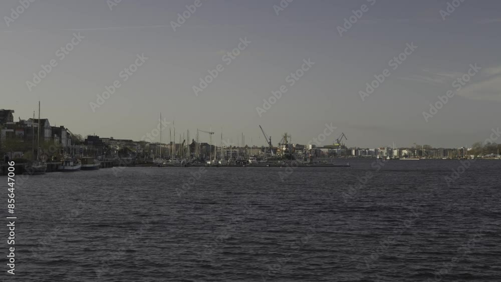 Rostock, Germany. Waterfront overlooking city and harbor on river unterwarnow in German city of Rostock in Deutschland. Unterwarnow Fluss in Mecklenburg-Vorpommern. Rostock, Germany. Waterfront overlooking city and harbor on river unterwarnow in German city of Rostock in Deutschland. Unterwarnow Fluss in Mecklenburg-Vorpommern.