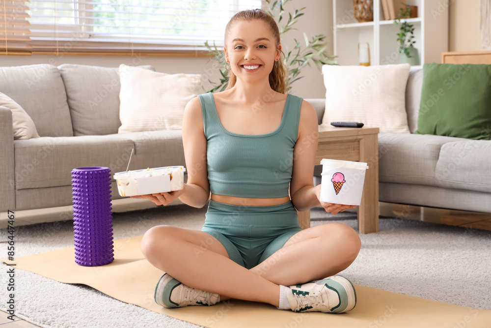 Sporty young woman with ice cream buckets sitting at home Sporty young woman with ice cream buckets sitting at home