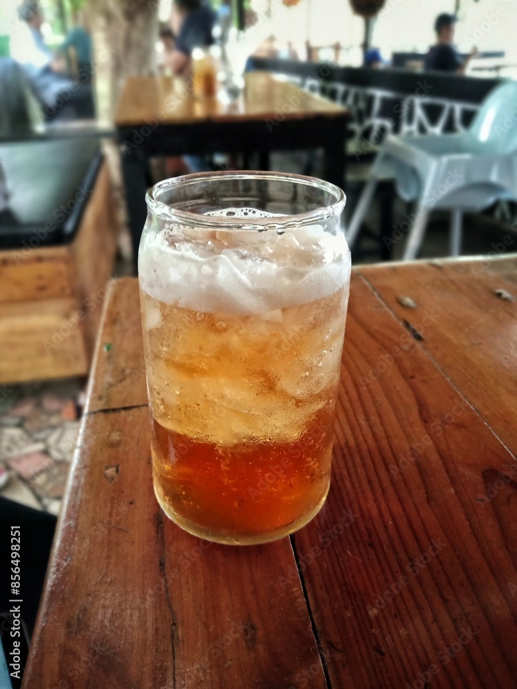 a glass filled with iced tea a glass filled with iced tea