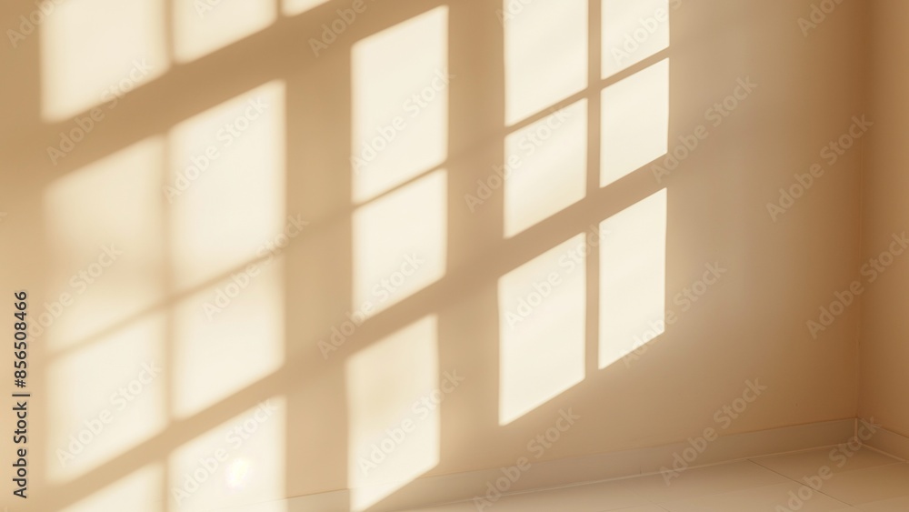 An empty room with beige walls and window shadows An empty room with beige walls and window shadows
