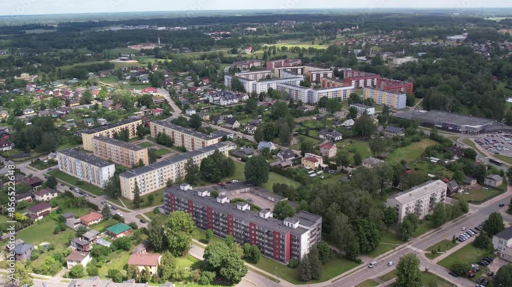 An aerial view of Valmiera city, showcasing its blend of urban and natural elements. The city is surrounded by lush greenery, with residential buildings, roads, and parks harmoniously landscape. An aerial view of Valmiera city, showcasing its blend of urban and natural elements. The city is surrounded by lush greenery, with residential buildings, roads, and parks harmoniously landscape.