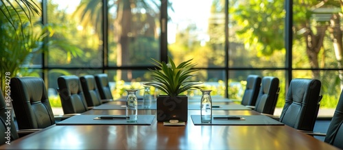 A large conference room with a black leather chair and two black office chairs