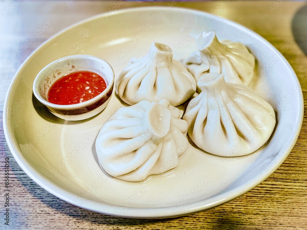 Khinkali in a plate with sauce