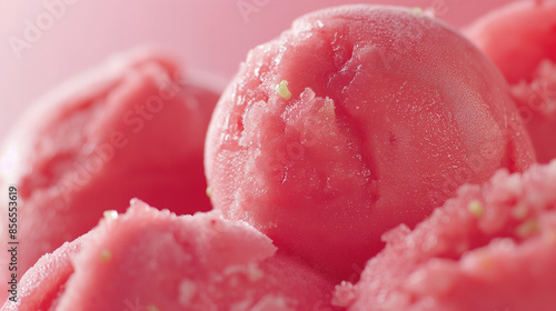 A closeup of exotic guava and lime sorbet, its bright pink color and tangy flavor highlighted against a white background
