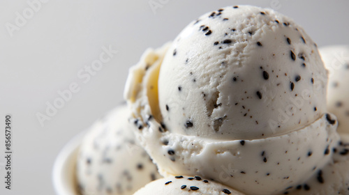 Chic coconut and black sesame gelato, a closeup of chic coconut and black sesame gelato, its creamy white texture with black specks against a white background