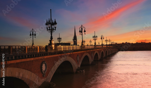 View of the Pont de pierre with sunset sky scene which The Pont de pierre crossing Garonne river	 photo